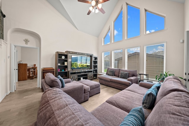 living room featuring high vaulted ceiling, light hardwood / wood-style flooring, and ceiling fan