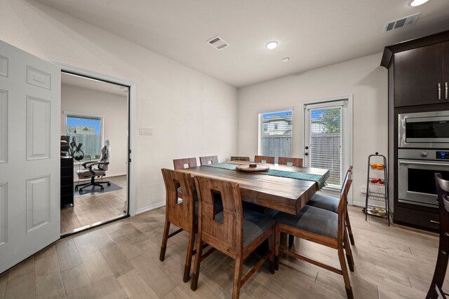 dining space with light wood-type flooring