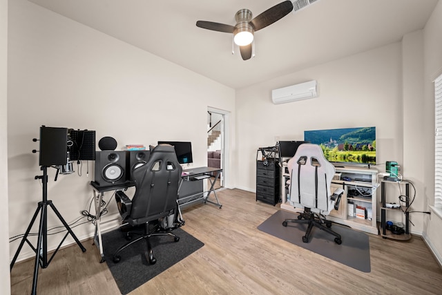 office area featuring ceiling fan, light hardwood / wood-style floors, and a wall mounted AC