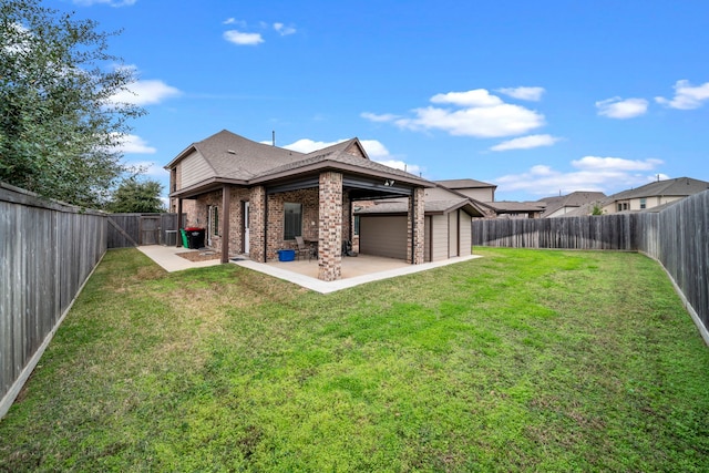 rear view of house with a yard and a patio