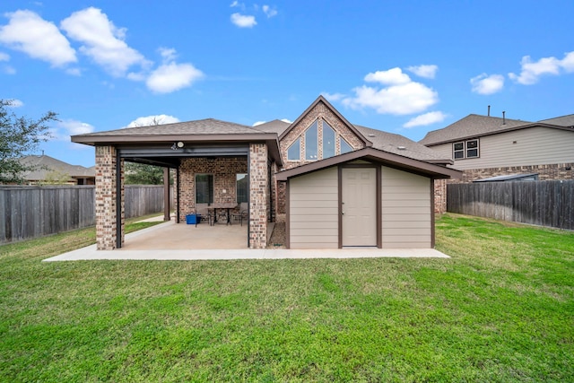 rear view of house with a patio area and a lawn