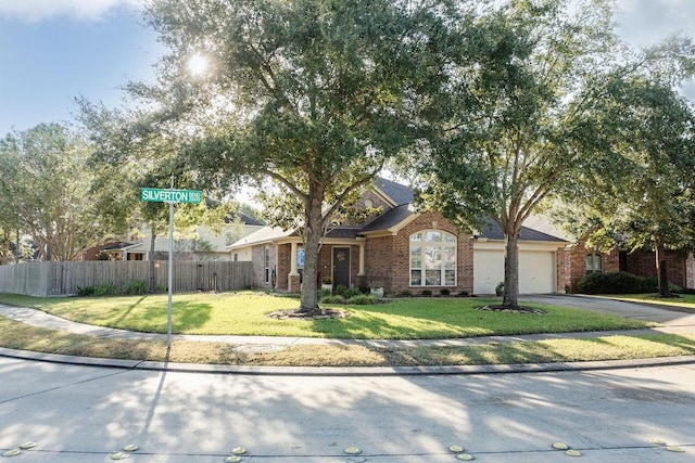 single story home featuring a garage and a front lawn