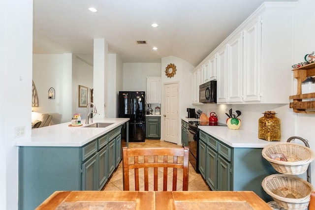 kitchen with white cabinetry, sink, light tile patterned floors, and black appliances