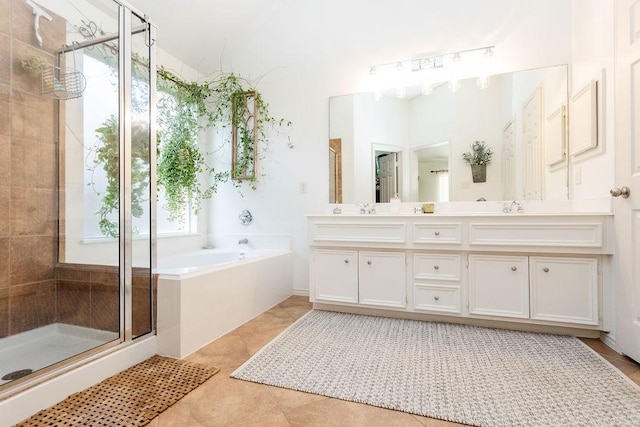 bathroom with tile patterned flooring, vanity, and separate shower and tub