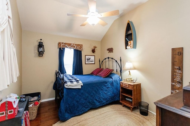 bedroom featuring ceiling fan, dark hardwood / wood-style flooring, and vaulted ceiling