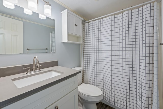 bathroom with a shower with curtain, vanity, toilet, and crown molding