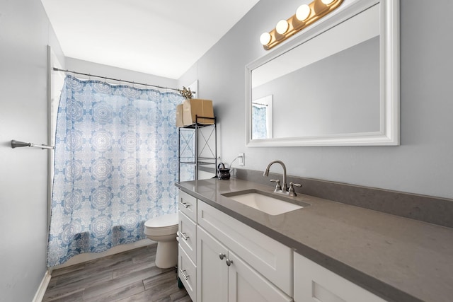 bathroom with vanity, hardwood / wood-style flooring, and toilet