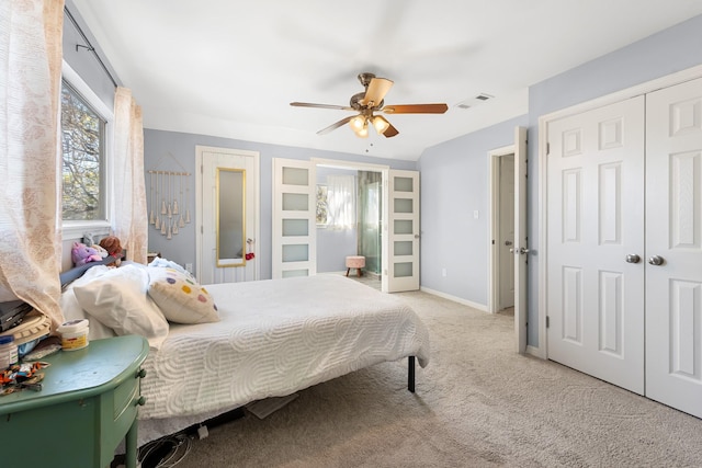 carpeted bedroom featuring ceiling fan and a closet