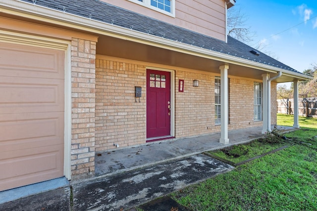 entrance to property with a porch and a garage