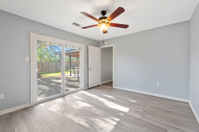 unfurnished room with light wood-type flooring and ceiling fan