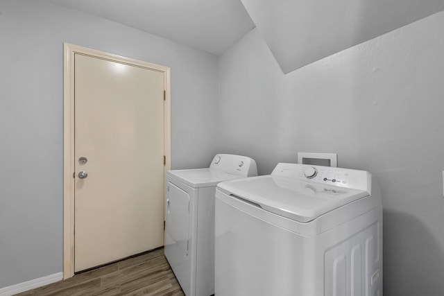 laundry area with light wood-type flooring and washing machine and clothes dryer