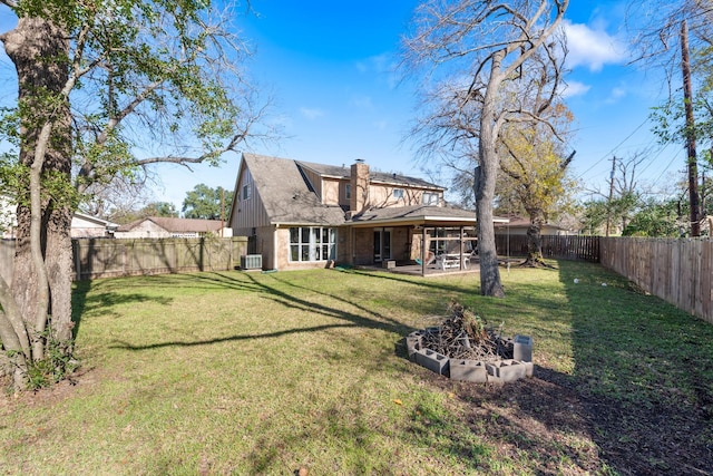 view of yard featuring cooling unit, a patio, and an outdoor fire pit