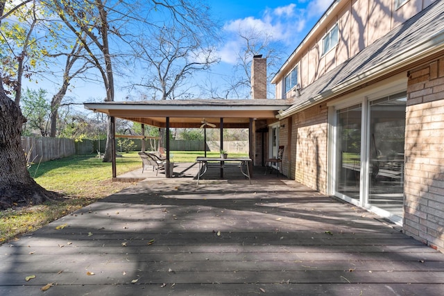 deck with a lawn and ceiling fan