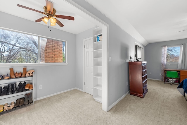 interior space featuring ceiling fan and vaulted ceiling