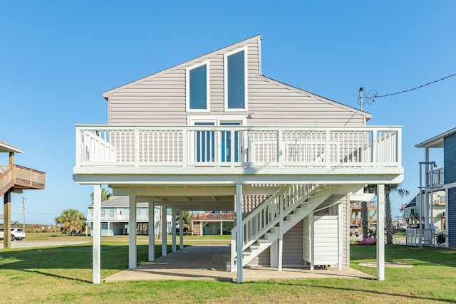 rear view of house with a yard and a wooden deck