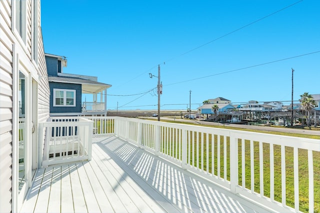 wooden terrace with a yard