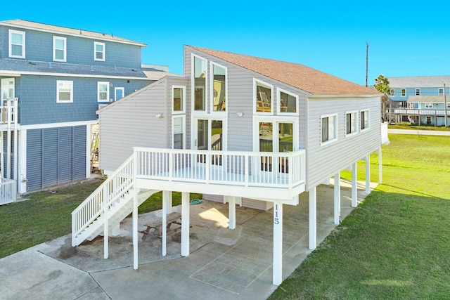 rear view of property featuring a yard and a carport