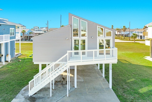 back of property with a residential view, a lawn, a carport, and a patio