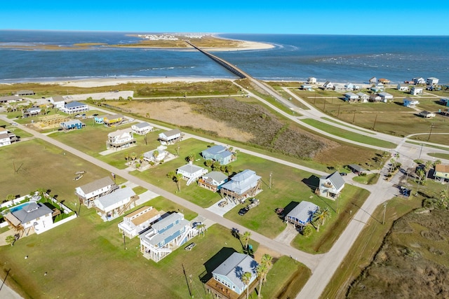 birds eye view of property with a beach view and a water view