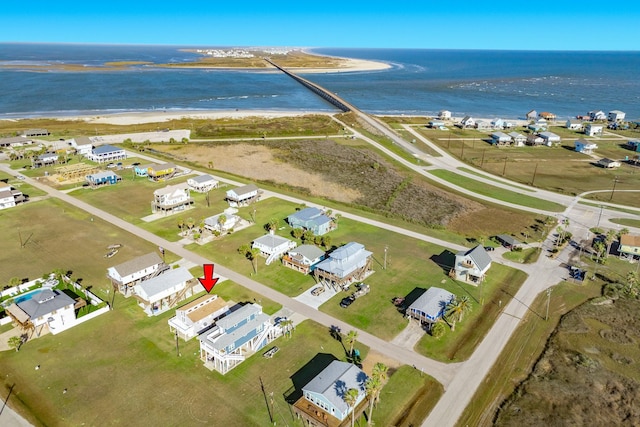 drone / aerial view featuring a beach view and a water view