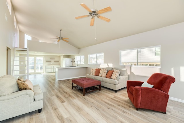 living room with ceiling fan, high vaulted ceiling, a healthy amount of sunlight, and light hardwood / wood-style floors