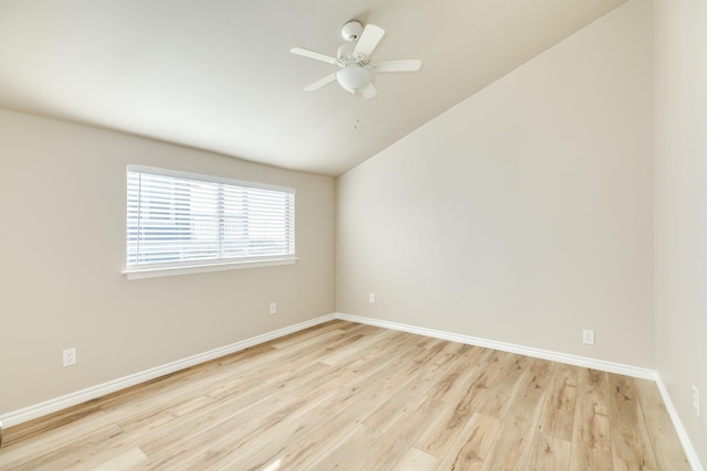 empty room with ceiling fan, light hardwood / wood-style floors, and lofted ceiling