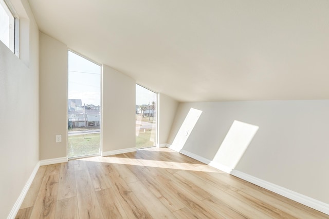 bonus room featuring light hardwood / wood-style floors and lofted ceiling