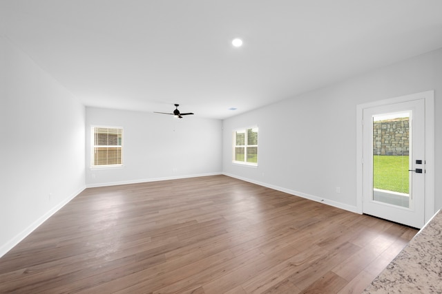 spare room with hardwood / wood-style floors and ceiling fan