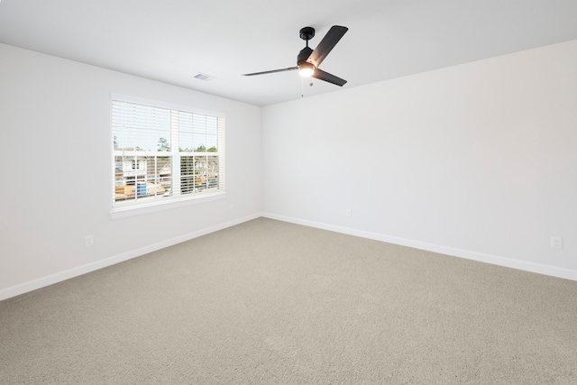 carpeted empty room featuring ceiling fan