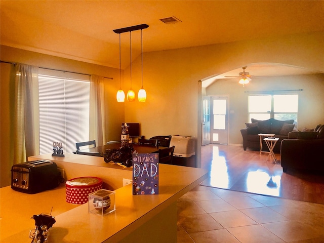 dining area featuring ceiling fan and tile patterned flooring