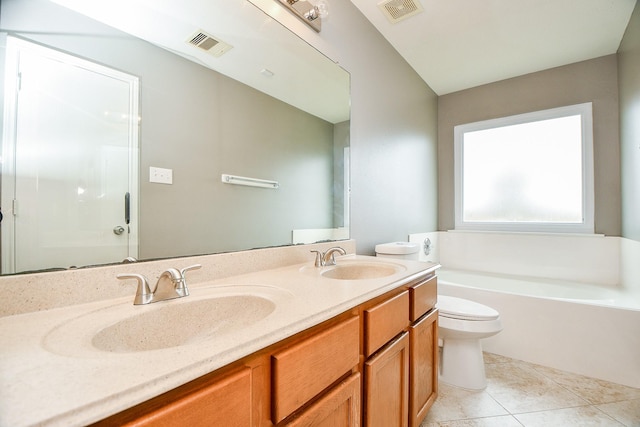 bathroom with vanity, tile patterned flooring, a bathtub, and toilet