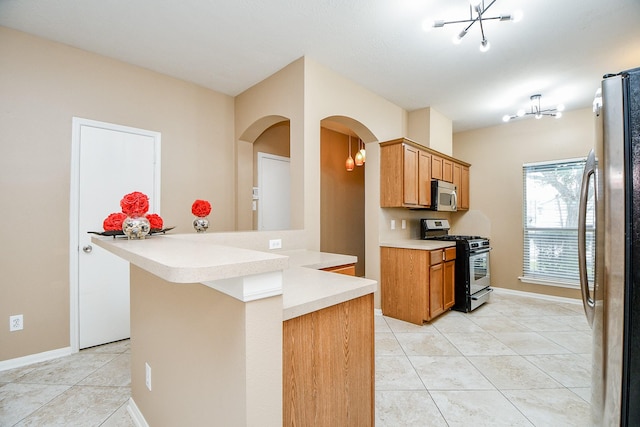 kitchen with light tile patterned flooring, appliances with stainless steel finishes, and kitchen peninsula