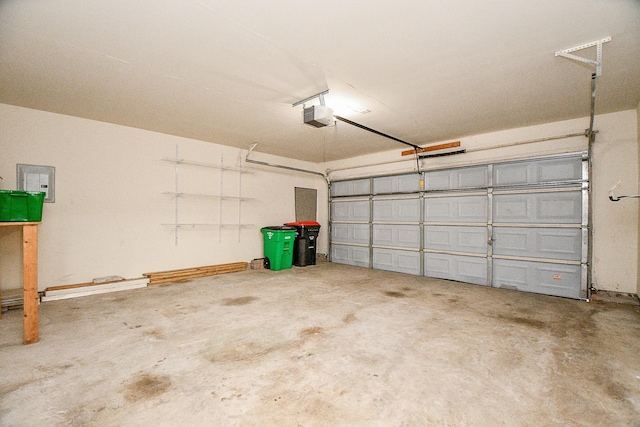 garage featuring a garage door opener and electric panel