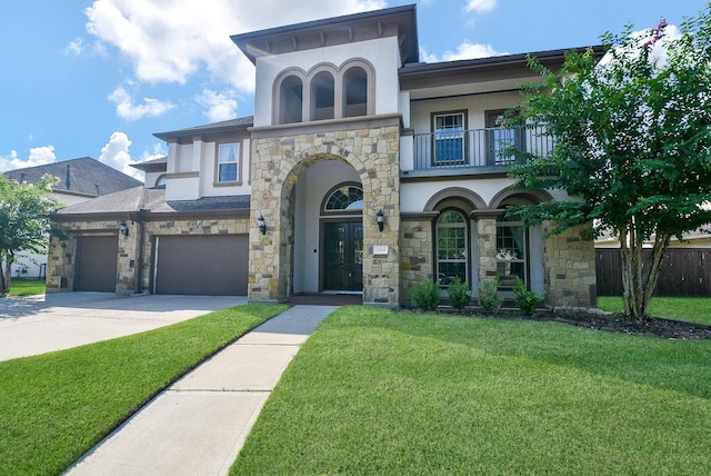 view of front of property featuring a balcony, a front yard, and a garage