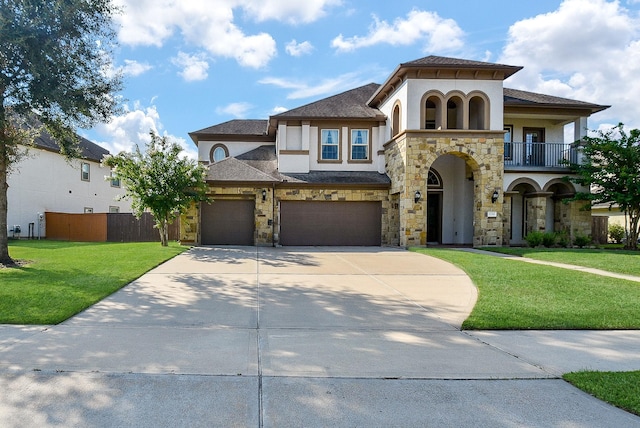 mediterranean / spanish-style home featuring a front yard, a balcony, and a garage