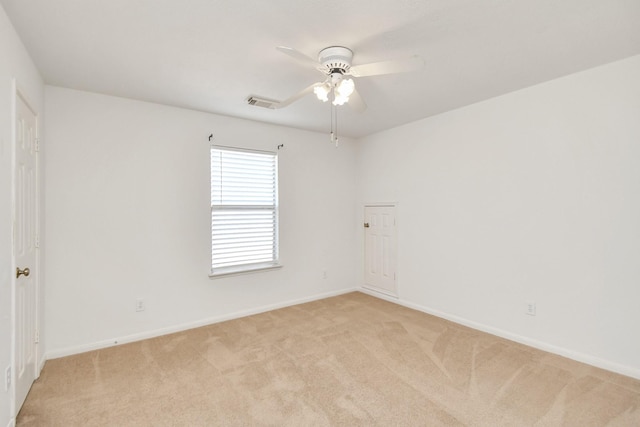 empty room featuring ceiling fan and light colored carpet