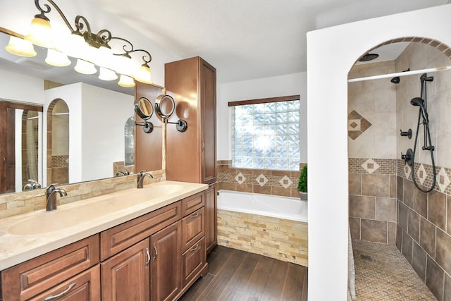 bathroom with wood-type flooring, vanity, and separate shower and tub