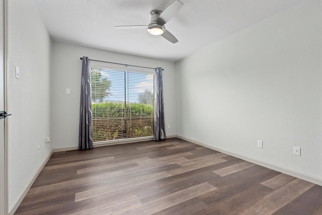 empty room with dark hardwood / wood-style floors and ceiling fan