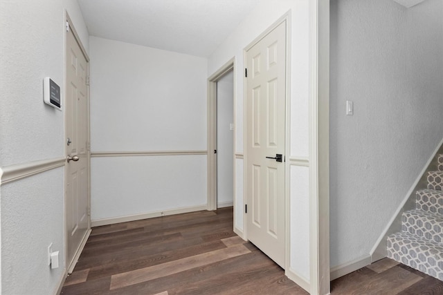 hallway with dark hardwood / wood-style floors