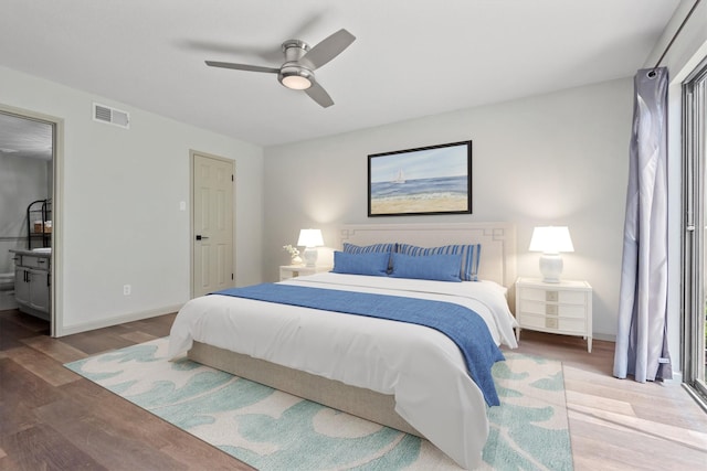 bedroom with ensuite bath, ceiling fan, and hardwood / wood-style flooring