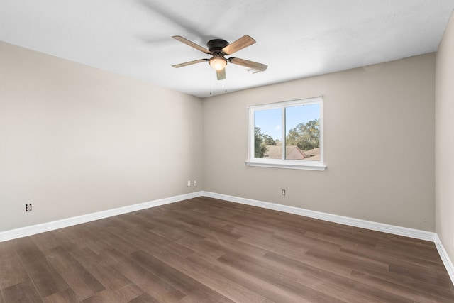 spare room featuring ceiling fan and dark wood-type flooring