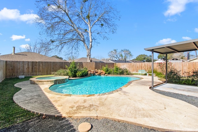 view of swimming pool featuring a patio area and an in ground hot tub