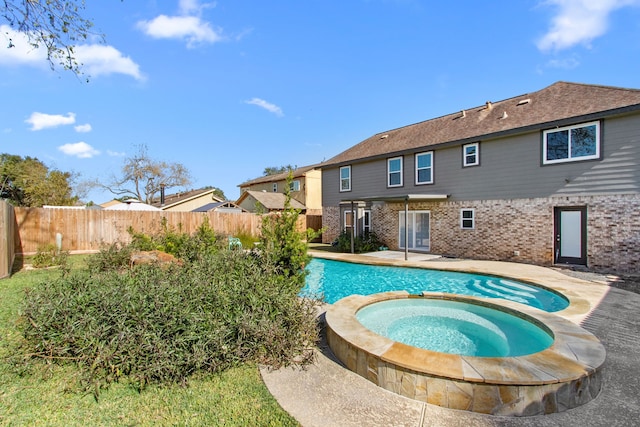 view of swimming pool with an in ground hot tub