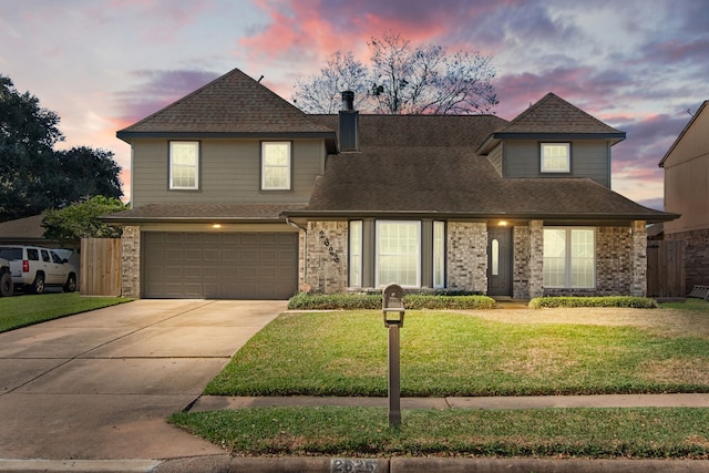 view of front of property with a lawn and a garage