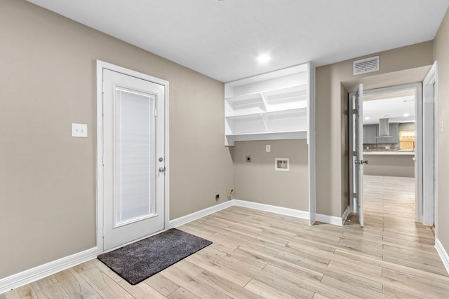 laundry area featuring electric dryer hookup, light hardwood / wood-style floors, hookup for a gas dryer, and hookup for a washing machine