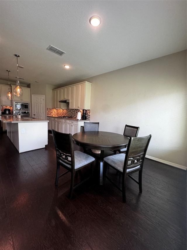 dining area with dark hardwood / wood-style flooring