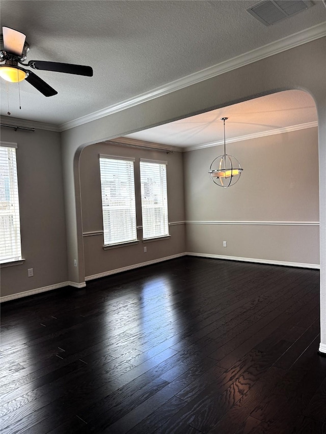 spare room with a textured ceiling, dark hardwood / wood-style floors, a healthy amount of sunlight, and ceiling fan with notable chandelier