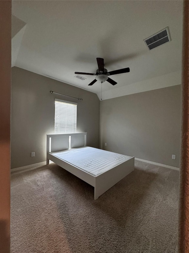 unfurnished bedroom with ceiling fan, carpet floors, and lofted ceiling