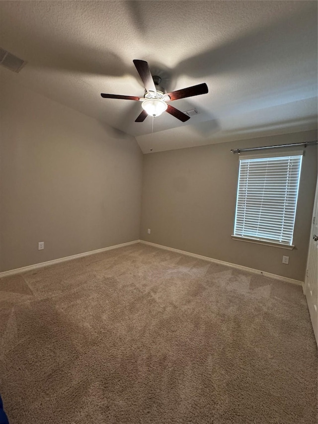 unfurnished room with a textured ceiling, carpet floors, ceiling fan, and lofted ceiling