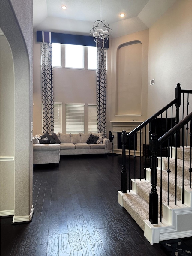 interior space featuring a notable chandelier and dark wood-type flooring